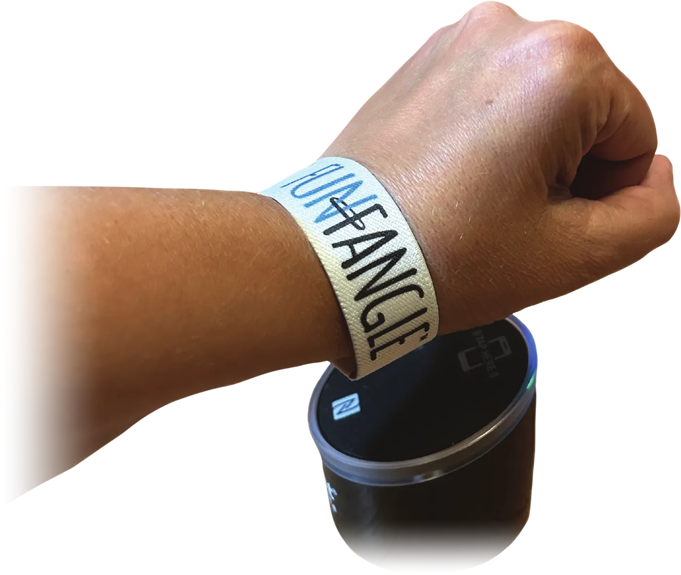 A wrist wearing a FunFangle stretch wristband, held over the round tap reader
